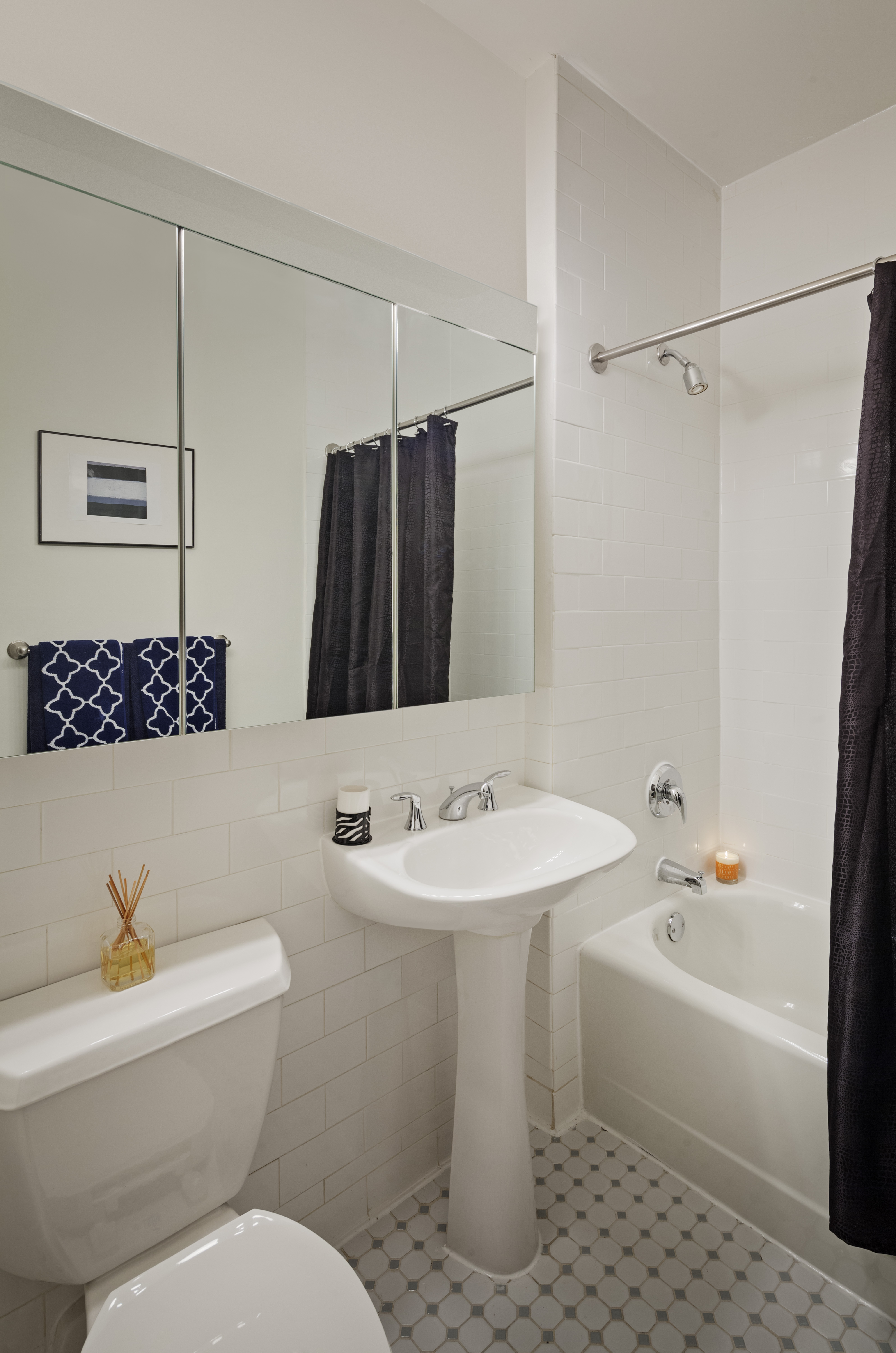 a white sink sitting under a mirror