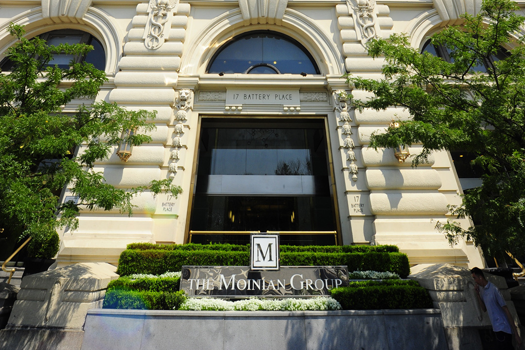 a close up of a flower garden in front of a building