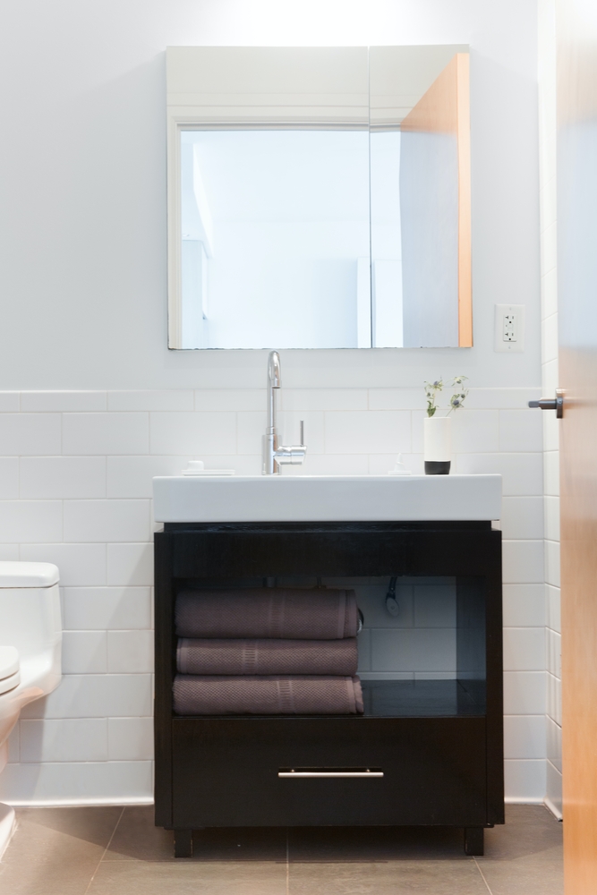 a room with a sink and a mirror